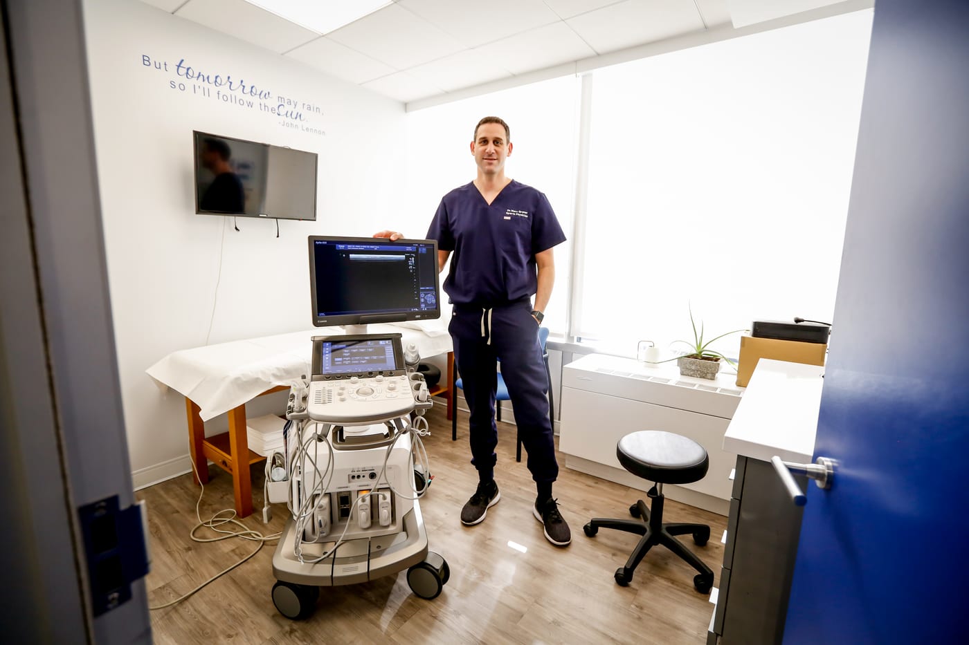 Dr. Marc Gruner in a procedure room with a diagnostic ultrasound machine